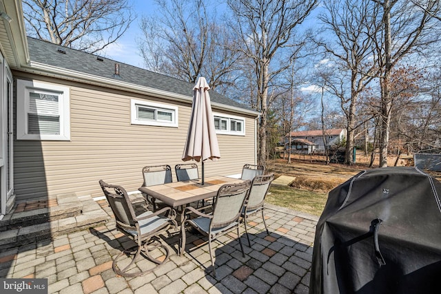 view of patio with outdoor dining area and a grill