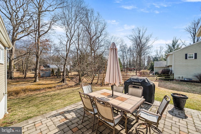 view of patio featuring outdoor dining area, area for grilling, and fence