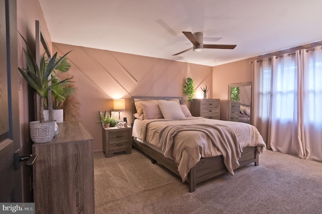 bedroom with a ceiling fan and light carpet