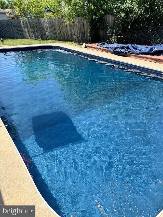 view of swimming pool with a fenced backyard and a fenced in pool