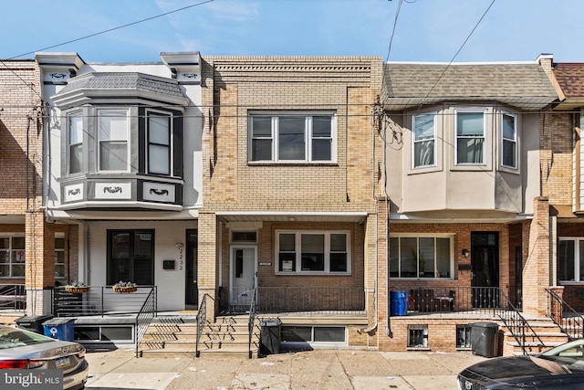 townhome / multi-family property featuring brick siding