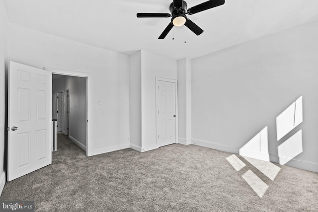 unfurnished bedroom featuring carpet floors, baseboards, and a ceiling fan