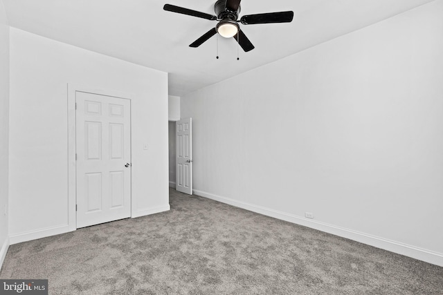 unfurnished bedroom with carpet, baseboards, and ceiling fan