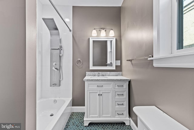 bathroom with tile patterned flooring, vanity, baseboards, and bathing tub / shower combination