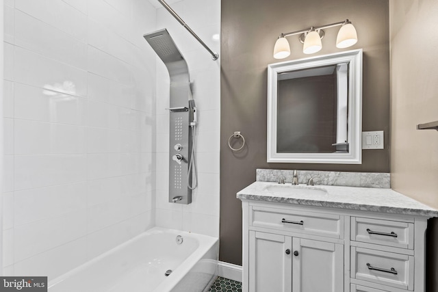 bathroom featuring bathtub / shower combination, baseboards, and vanity