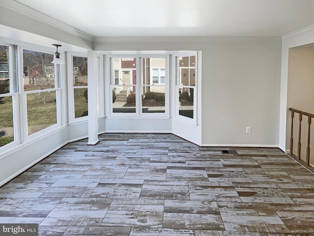 unfurnished sunroom featuring a wealth of natural light