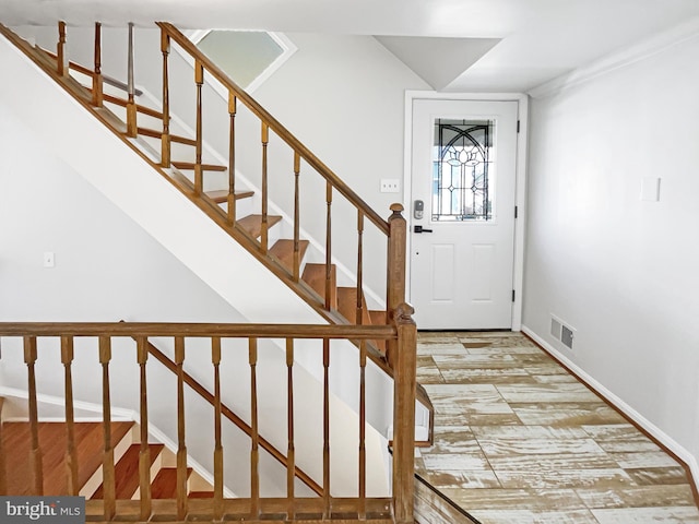 entrance foyer featuring visible vents and stairway