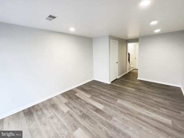 finished below grade area featuring recessed lighting, visible vents, baseboards, and wood finished floors