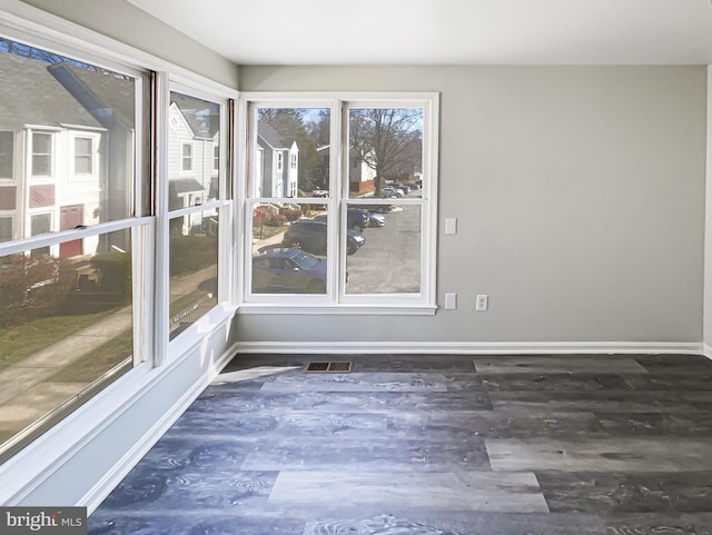 unfurnished sunroom featuring visible vents