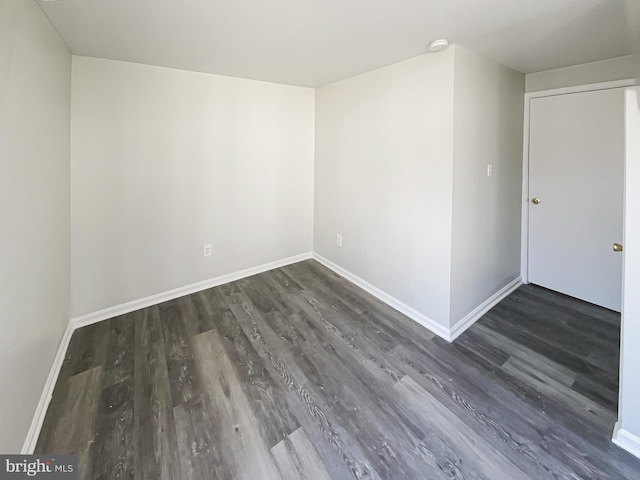 empty room featuring baseboards and wood finished floors