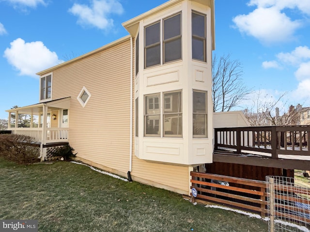 view of property exterior with a lawn