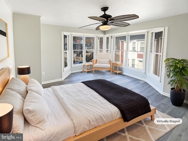 bedroom featuring ceiling fan, baseboards, and wood finished floors