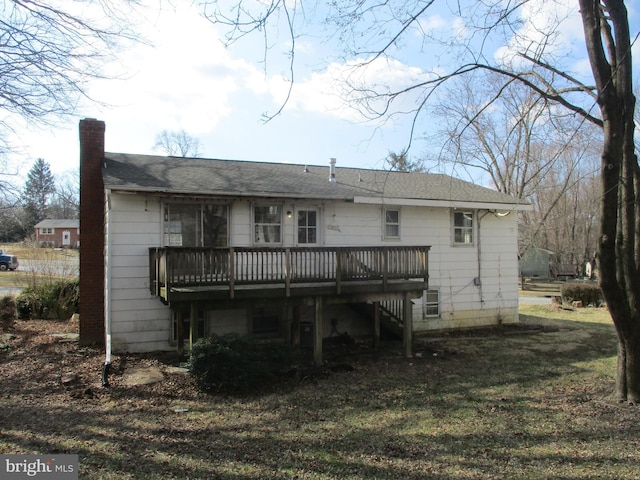 rear view of property featuring a deck and a chimney