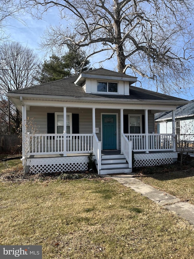 bungalow-style house with a porch and a front yard