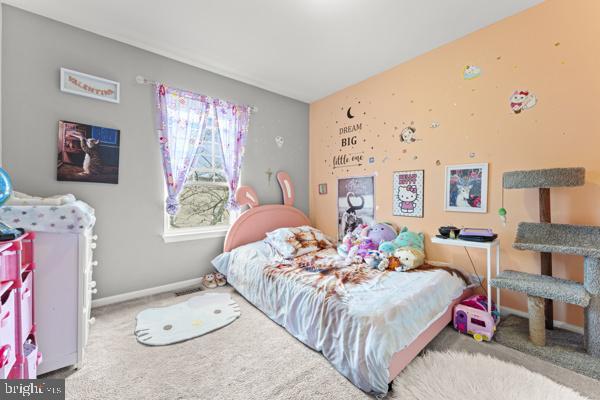 carpeted bedroom featuring baseboards