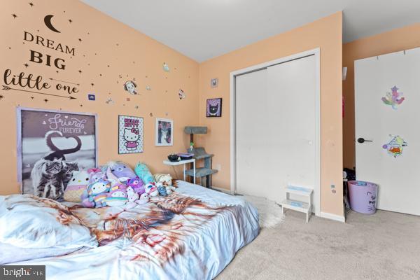 bedroom with carpet and a closet