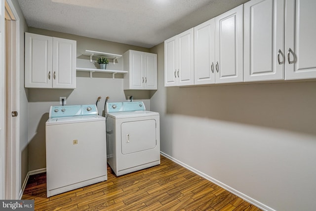 laundry room with independent washer and dryer, wood finished floors, cabinet space, and baseboards