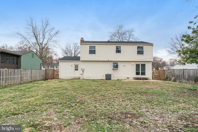 rear view of house with a yard, a chimney, a fenced backyard, and central air condition unit