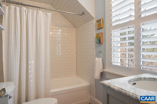 bathroom with toilet, shower / bath combo, and vanity