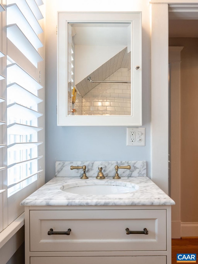 interior details featuring wood finished floors and vanity