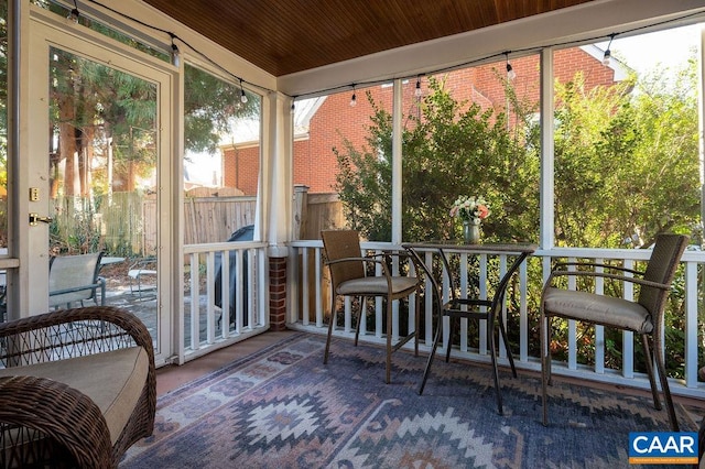 sunroom featuring plenty of natural light and wood ceiling