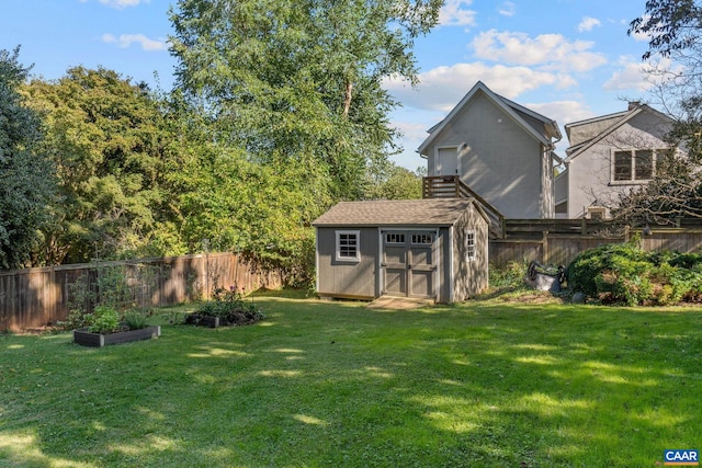 exterior space featuring an outbuilding, a fenced backyard, a yard, a vegetable garden, and a shed