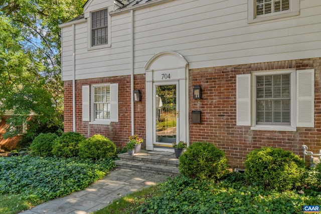 entrance to property with brick siding