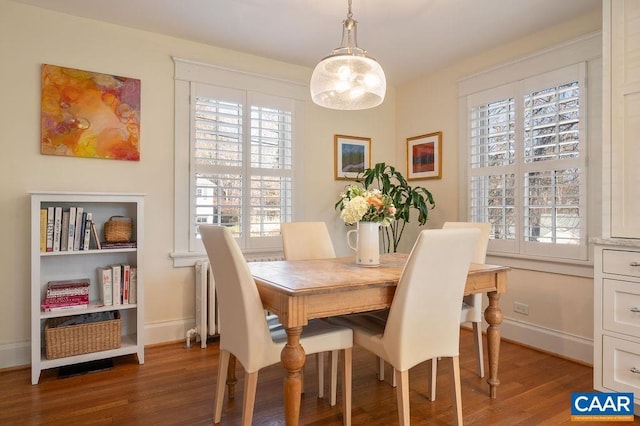 dining area with wood finished floors and baseboards