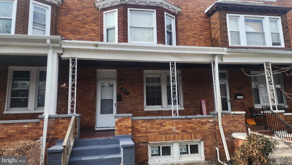 view of front of property featuring a porch and brick siding