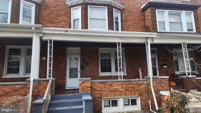 view of front of property featuring a porch and brick siding