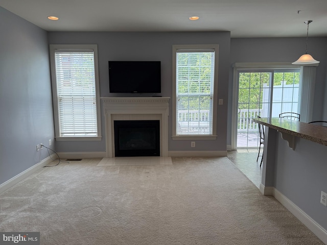 2114 Split Creek Ln, Hanover, MD 21076 - unfurnished living room with carpet floors, healthy amount of natural light, a fireplace with flush hearth, and recessed lighting