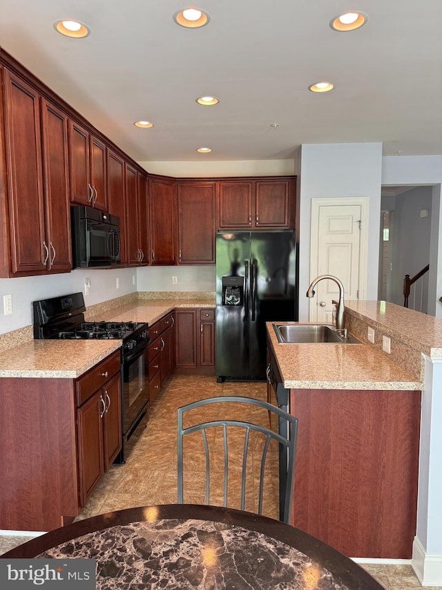 2114 Split Creek Ln, Hanover, MD 21076 - kitchen featuring black appliances, recessed lighting, a center island with sink, and light stone countertops