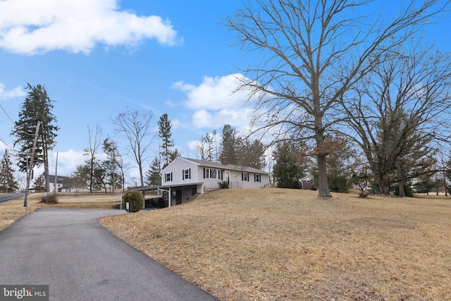 view of front of home with a front lawn and aphalt driveway