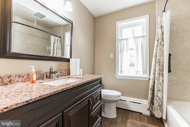 full bathroom with baseboard heating, wood finished floors, vanity, and a healthy amount of sunlight