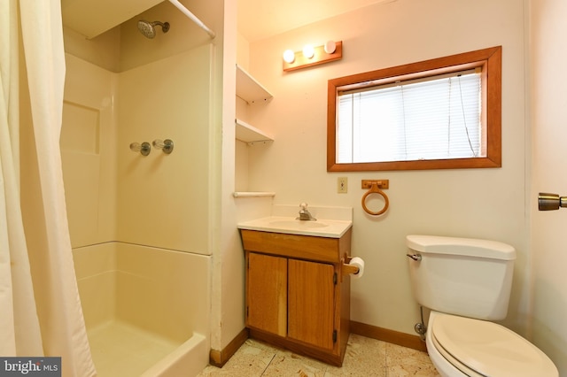 bathroom with a shower stall, toilet, and baseboards