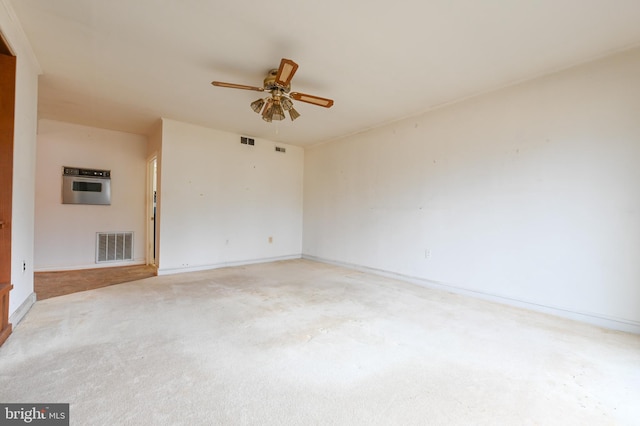 unfurnished room with ceiling fan, visible vents, and baseboards