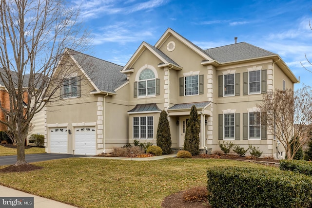 view of front of property with aphalt driveway, a front lawn, a garage, and stucco siding