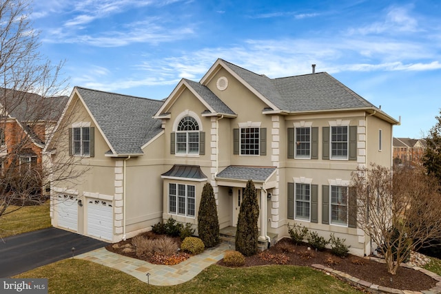 view of front of property featuring aphalt driveway, stucco siding, and a shingled roof