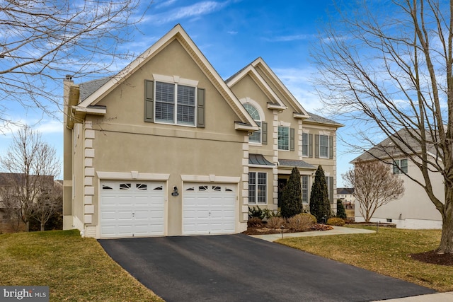 traditional home with a front yard, driveway, an attached garage, a chimney, and stucco siding