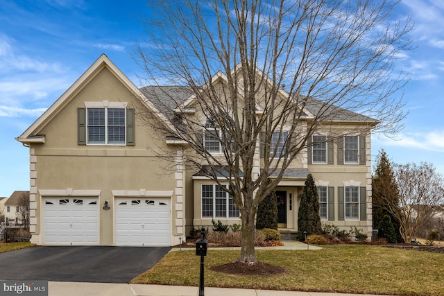 view of front of home featuring stucco siding, driveway, an attached garage, and a front lawn