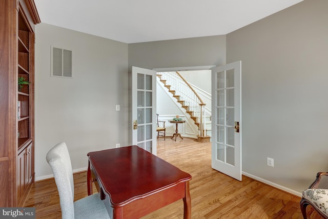 office with baseboards, french doors, visible vents, and light wood-type flooring