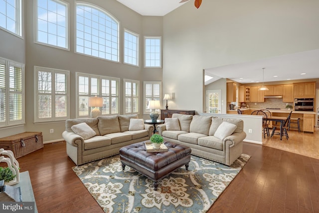 living room with recessed lighting, baseboards, and hardwood / wood-style floors