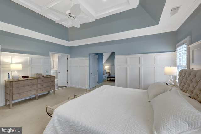 bedroom with a decorative wall, ornamental molding, coffered ceiling, and light carpet