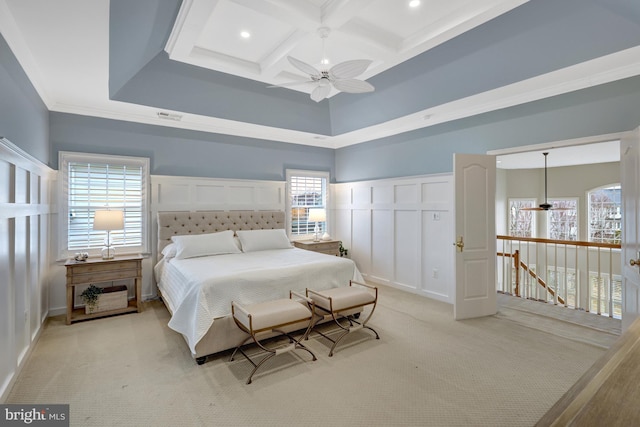 bedroom with beamed ceiling, coffered ceiling, a decorative wall, multiple windows, and light colored carpet