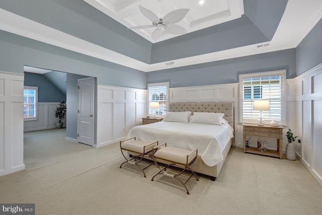 bedroom with a decorative wall, light colored carpet, ceiling fan, and ornamental molding