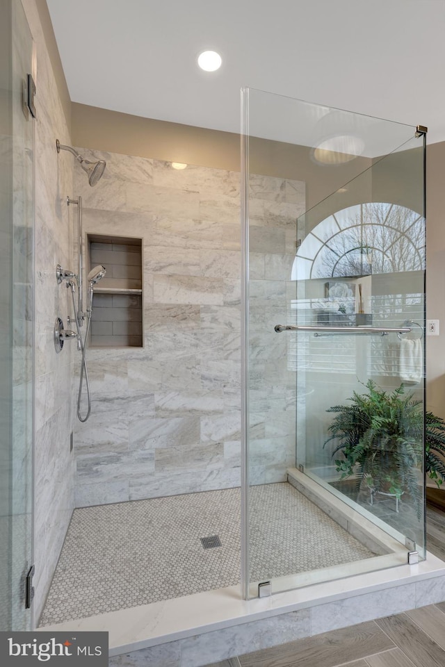 full bath featuring a shower stall