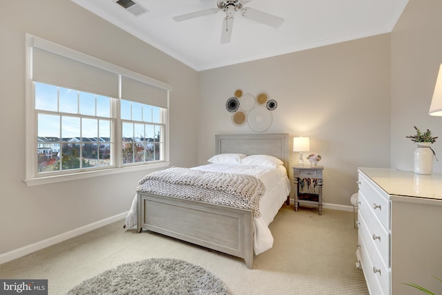 bedroom featuring baseboards, visible vents, ceiling fan, light carpet, and crown molding