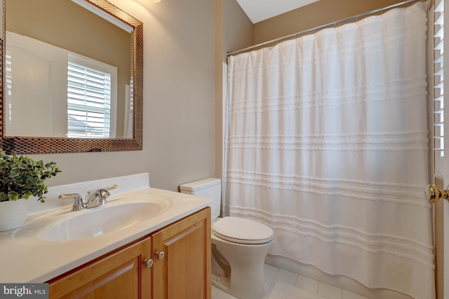 bathroom with vanity, curtained shower, toilet, and tile patterned flooring