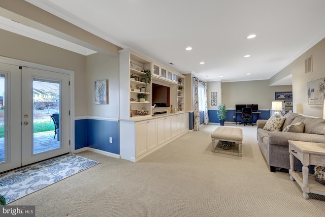 unfurnished living room featuring visible vents, ornamental molding, recessed lighting, french doors, and light colored carpet