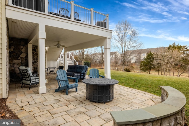 view of patio with a balcony, stairway, and a ceiling fan